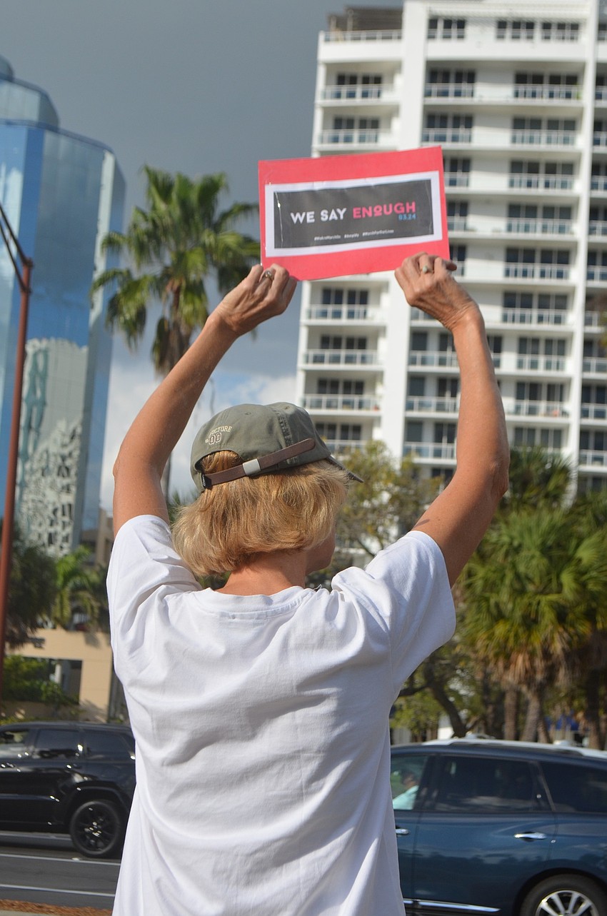 A sign at the demonstration reads 