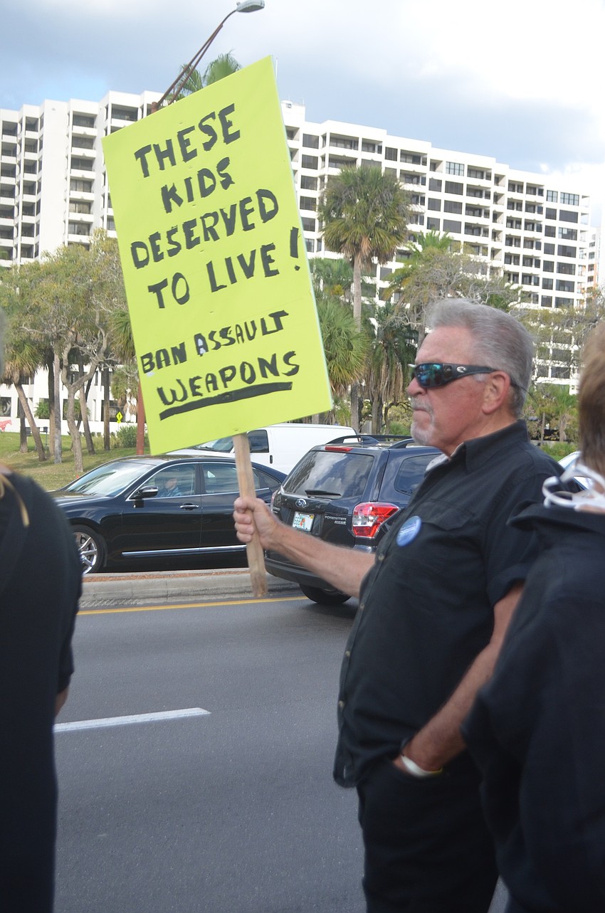 Phil Ruffin held a sign demanding a ban on assault weapons. 