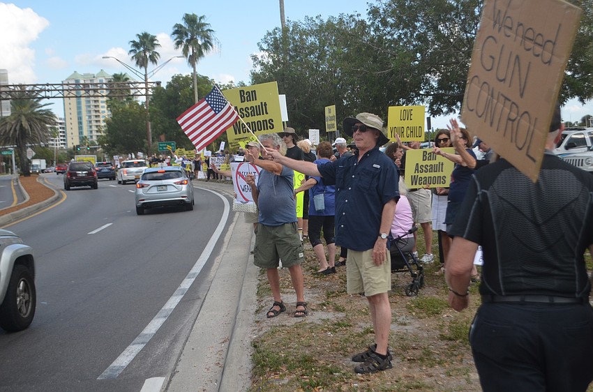 More than 200 demonstrators lined Bayfront Drive Thursday afternoon in support of broader gun regulations and to memorialize the victims of the Marjory Stoneman Douglas shootings.