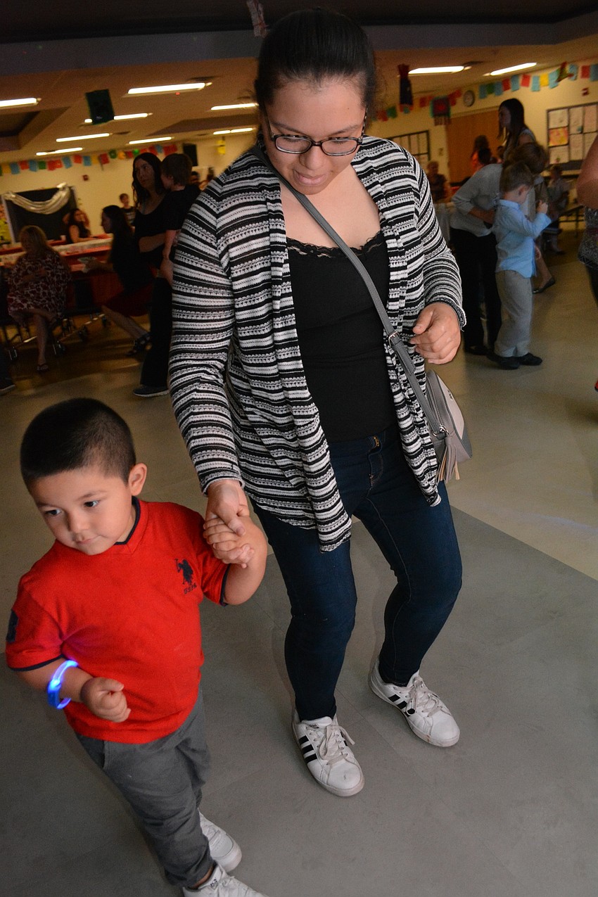 Brayan Jaimes, 3, dances with his big sister, Giselle, while their mom, Maria, dances with his brothers, Francisco and Alexander, not pictured.