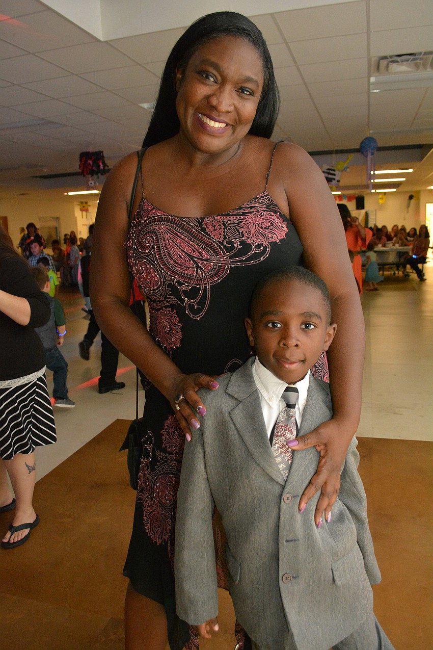 Chioma Michel and her son Evan, 7, ate pizza before arriving at the dance.