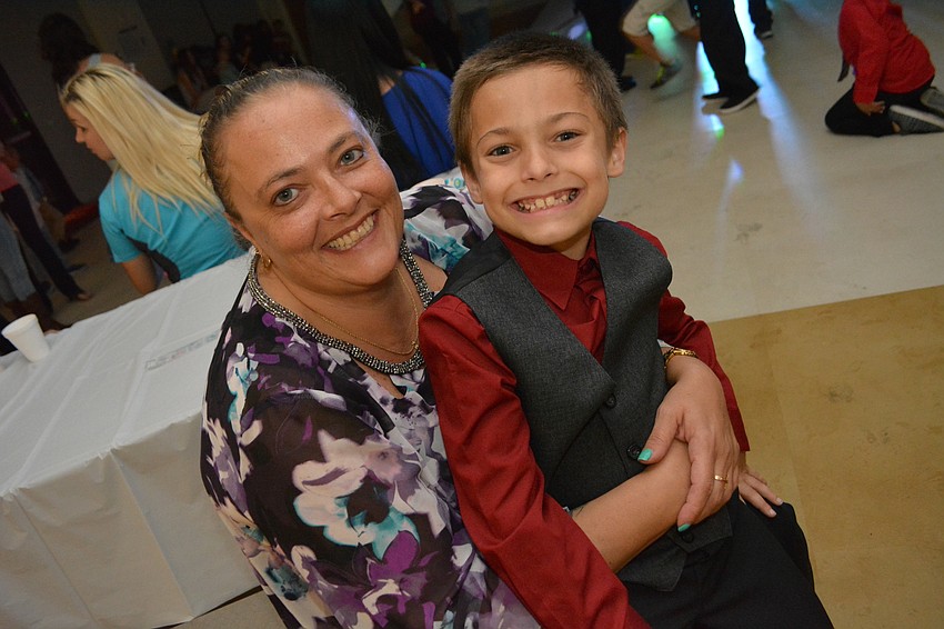 Rozalyn Charette snuggles with her son Vincent, who finally took a break from dancing. 