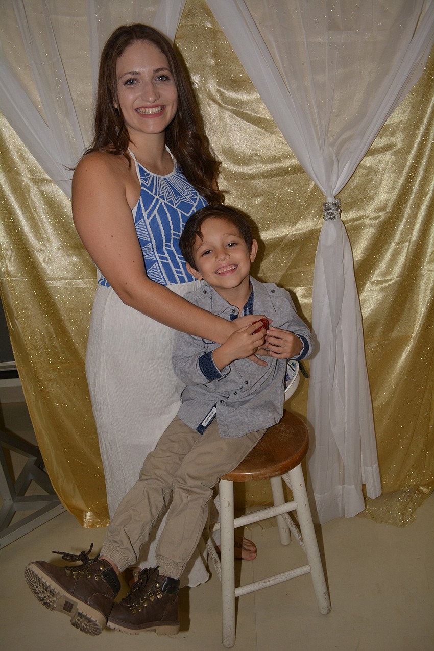 Leticia Cruz and her son Skyler, 5, attend their first dance and make sure to get a picture together.