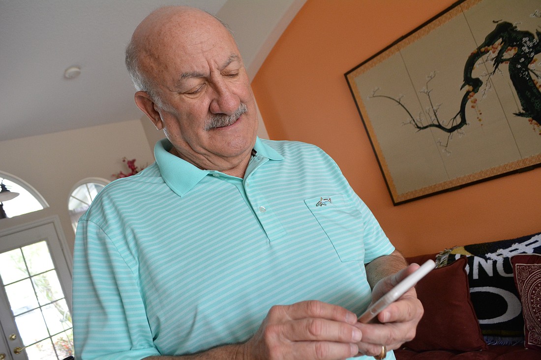 Summerfield resident Alan Roth checks to see the signal strength of his cell service in his home. He has trouble making and receiving calls from home.