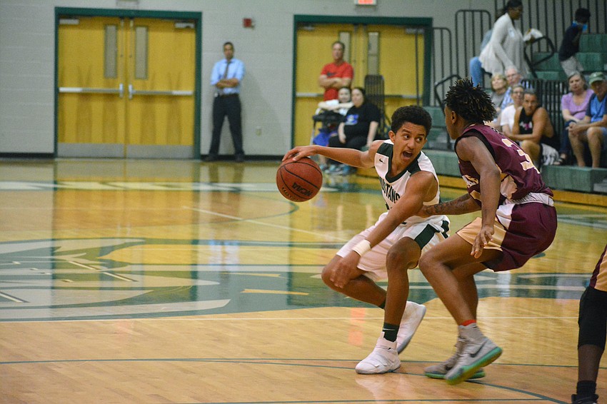 Sophomore Keon Buckley protects the ball from a Riverdale defender.