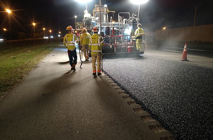 Construction workers lay the final layer of asphalt on a section of Interstate 75 Feb. 20. Courtesy image.