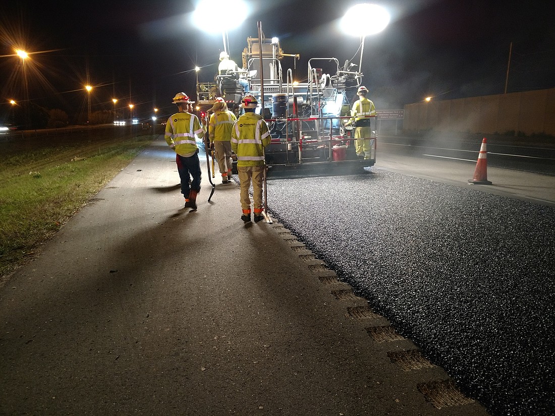 Construction workers lay the final layer of asphalt on a section of Interstate 75 Feb. 20. Courtesy image.