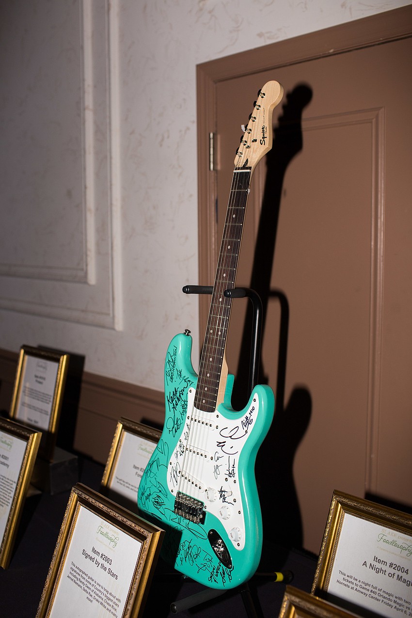 A guitar signed by country stars such as Chase Rice and Jerrod Niemann was available for bidding.