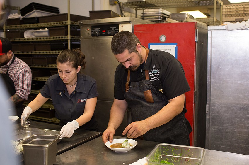 Chef Mark Majorie garnishes his dish.