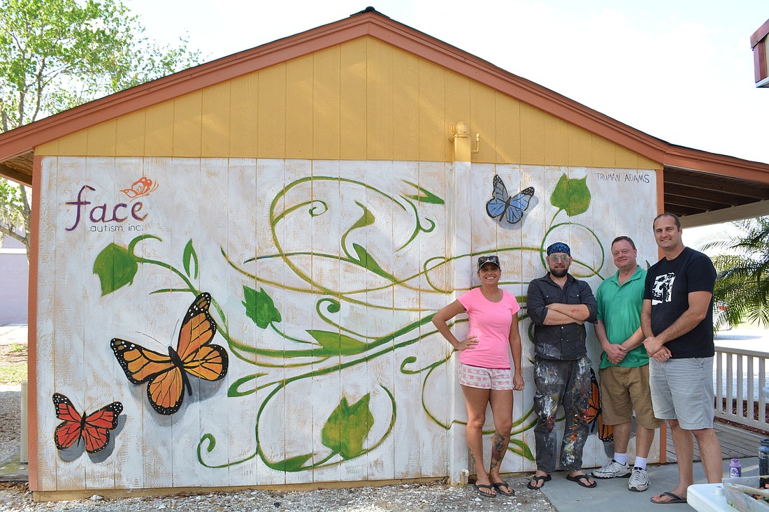 Sarasota Jeep Club member Yvonne Berger,  artist Truman Adams, winery owner Erik Hall and club founder and Face Autism volunteer Matt Bruback pose with the newly completed Face Autism mural at Fiorelli Winery and Vineyard.