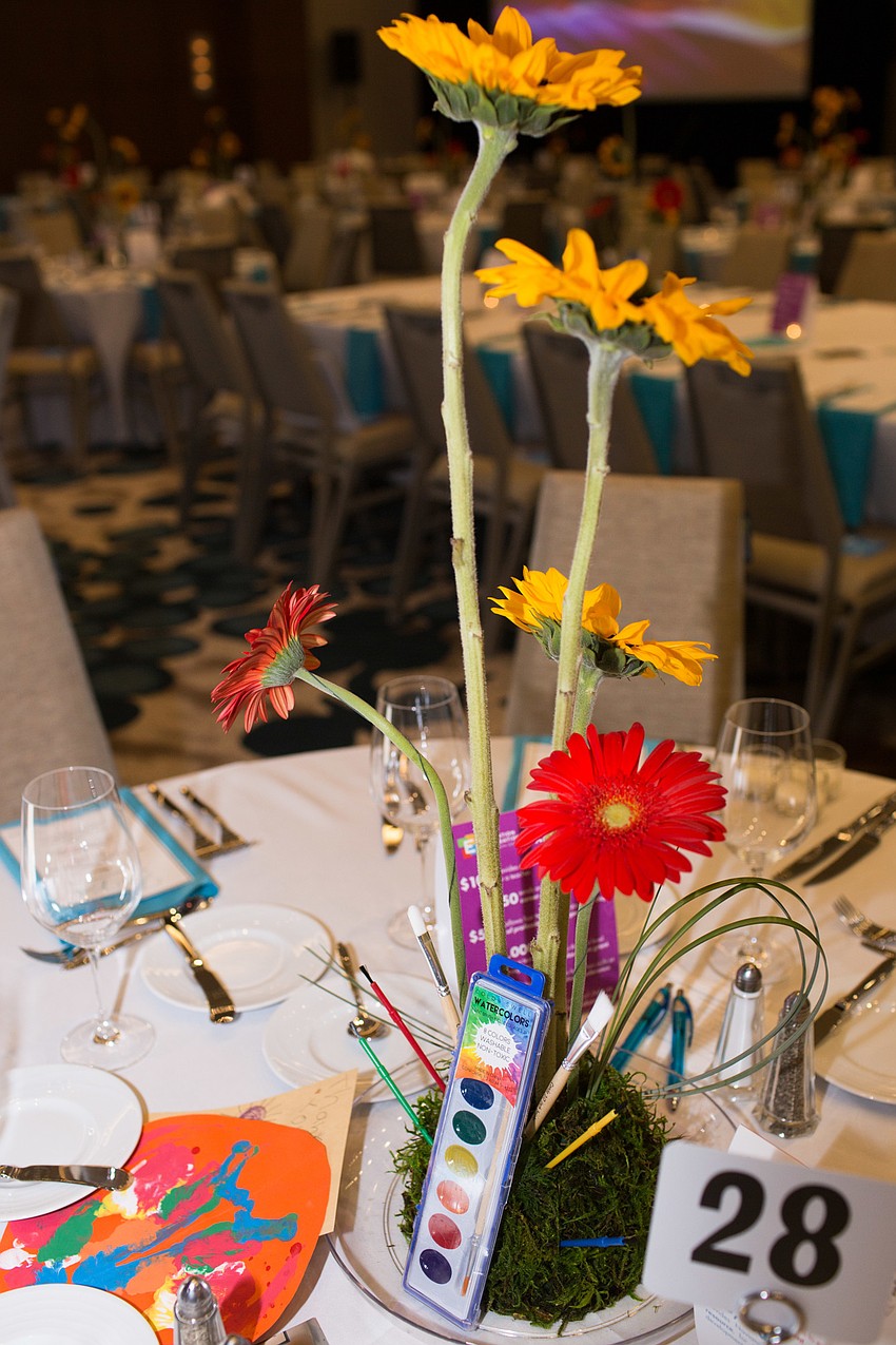 The tables were decorated with faux flowers and a watercolor set.