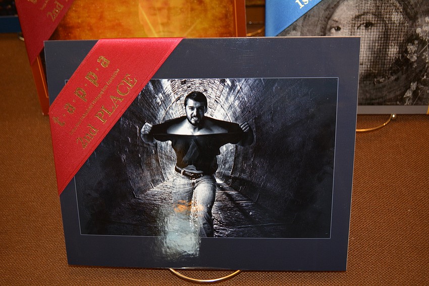 Kathryn DeYoung photographed this body builder ripping off his shirt, per his request. The trick was making the background neat. DeYoung combined her image with another.