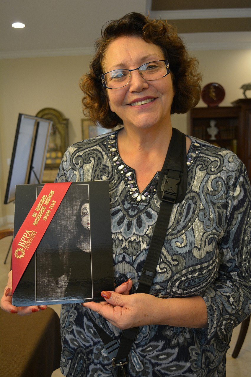 Kathryn DeYoung holds one of her favorite works.