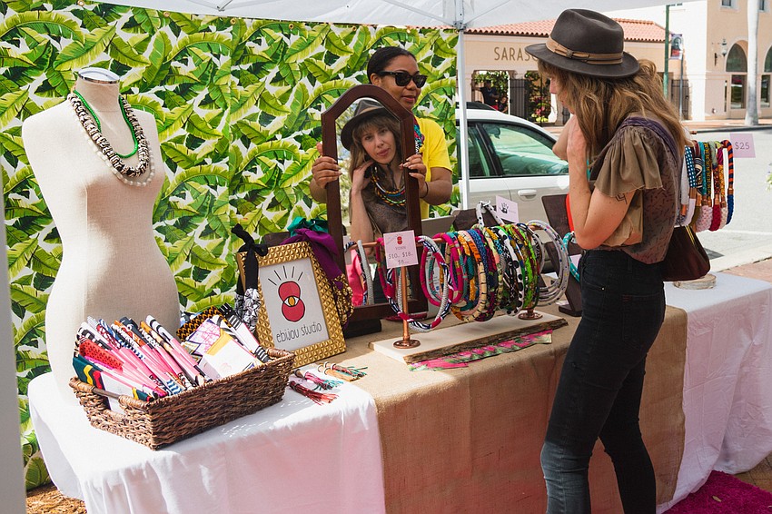 Erin Murphy tries on a necklace from Elma Felix-Lamontagne's Ebijou Studio booth.