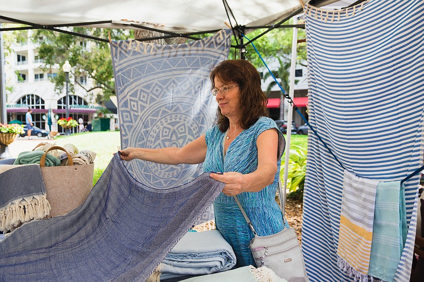 Shopper Veronica Martinez looks at a design from Mandalina Eco Towels and Blankets.