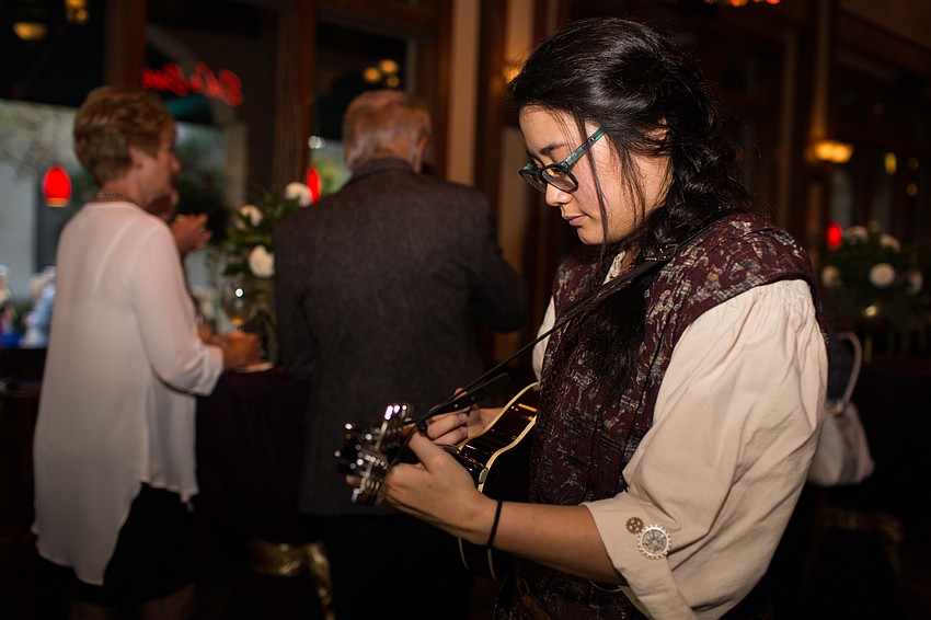 Eileen Doan entertains guests with music.