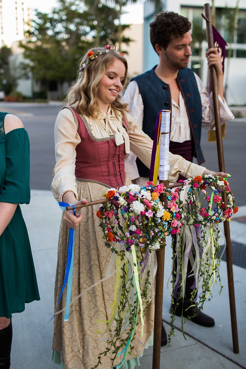 Erin Bradford hands out flower crowns to guests.