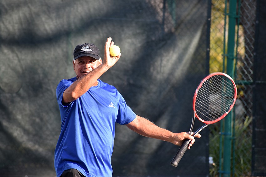 Sammy Aviles, tennis pro at The Longboat Key Club, waves to the crowd.