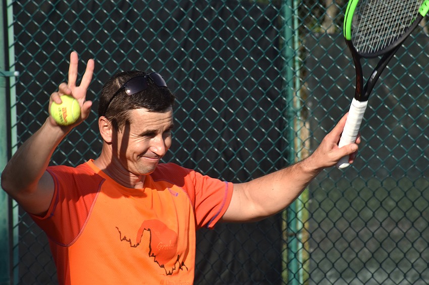 Sergiu, a tennis pro for The Longboat Key Tennis Center, waves to the crowd.