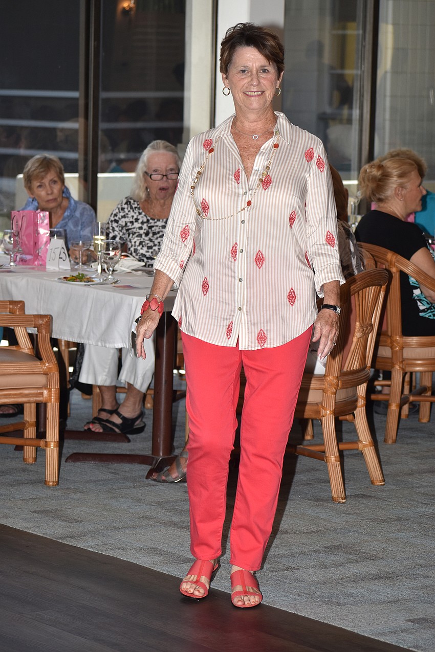 Marge Geiger smiles as she walks the room during the fashion show.