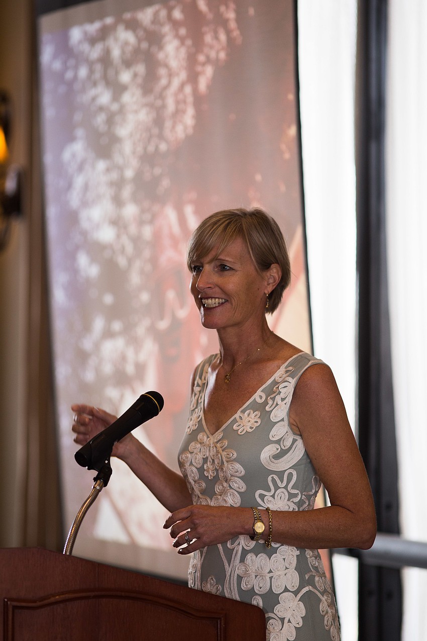 Sarah Fangman points to a photo of herself on a family vacation, saying that's when she knew she wanted to be a marine biologist.
