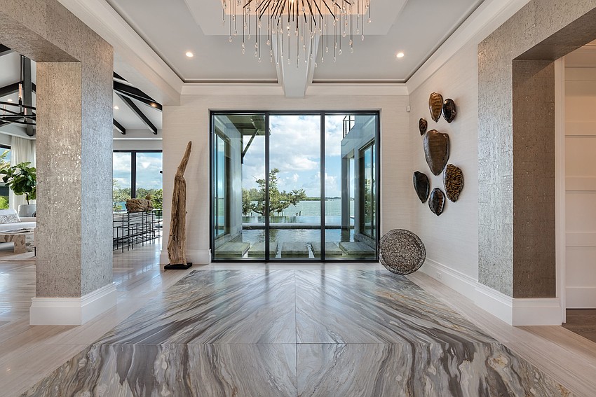 The interior was crafted with wood, marble and stone throughout, and was designed with coffered ceilings, moldings and textured wall coverings.