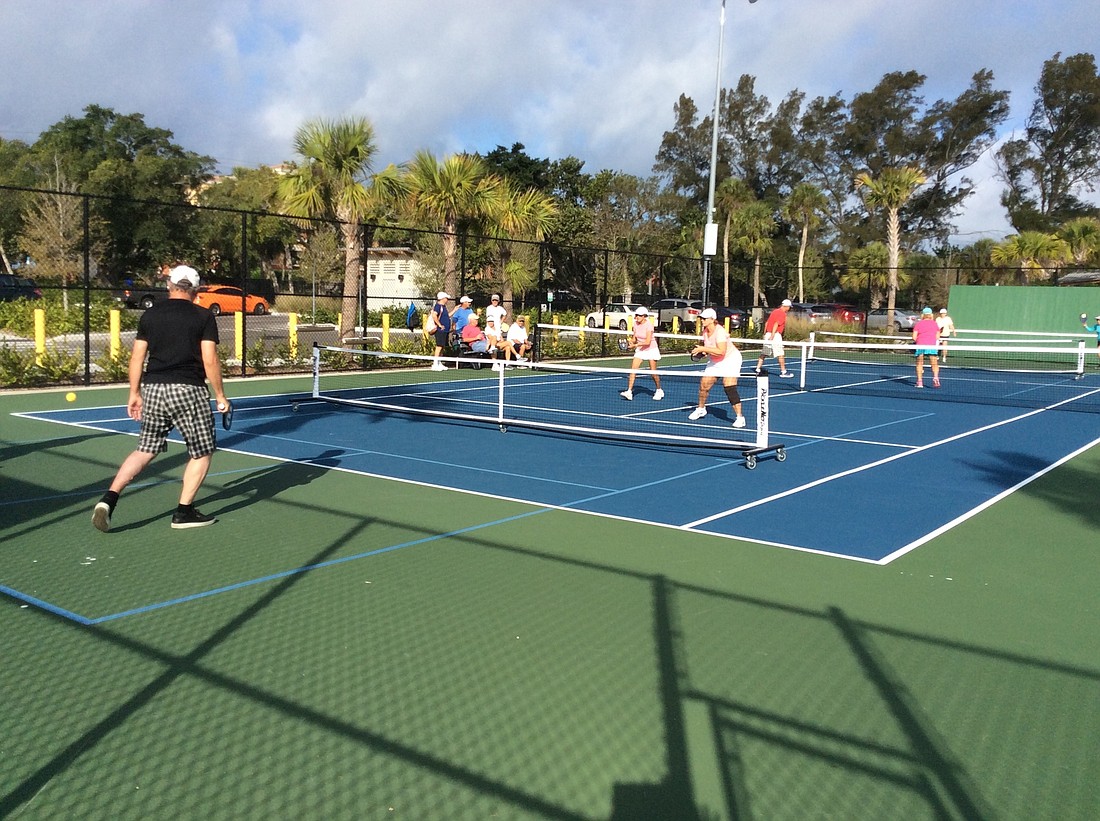 Pickleball players on both sides of a Bayfront Park tennis court enjoy their game on Thursday, March 1.