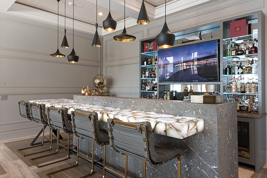 The property includes a lounge with an illuminated crystal agate countertop bar on top of a fossilized Jurassic brown marble base.