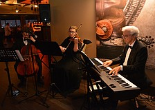 Sarasota Orchestra musicians Isaac Mingas, Joy Chatzistamatis and Thomas Pizzi provide live entertainment as guests arrive.