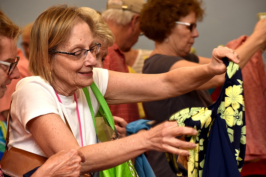 Irene Berman checks out the women’s clothing section.