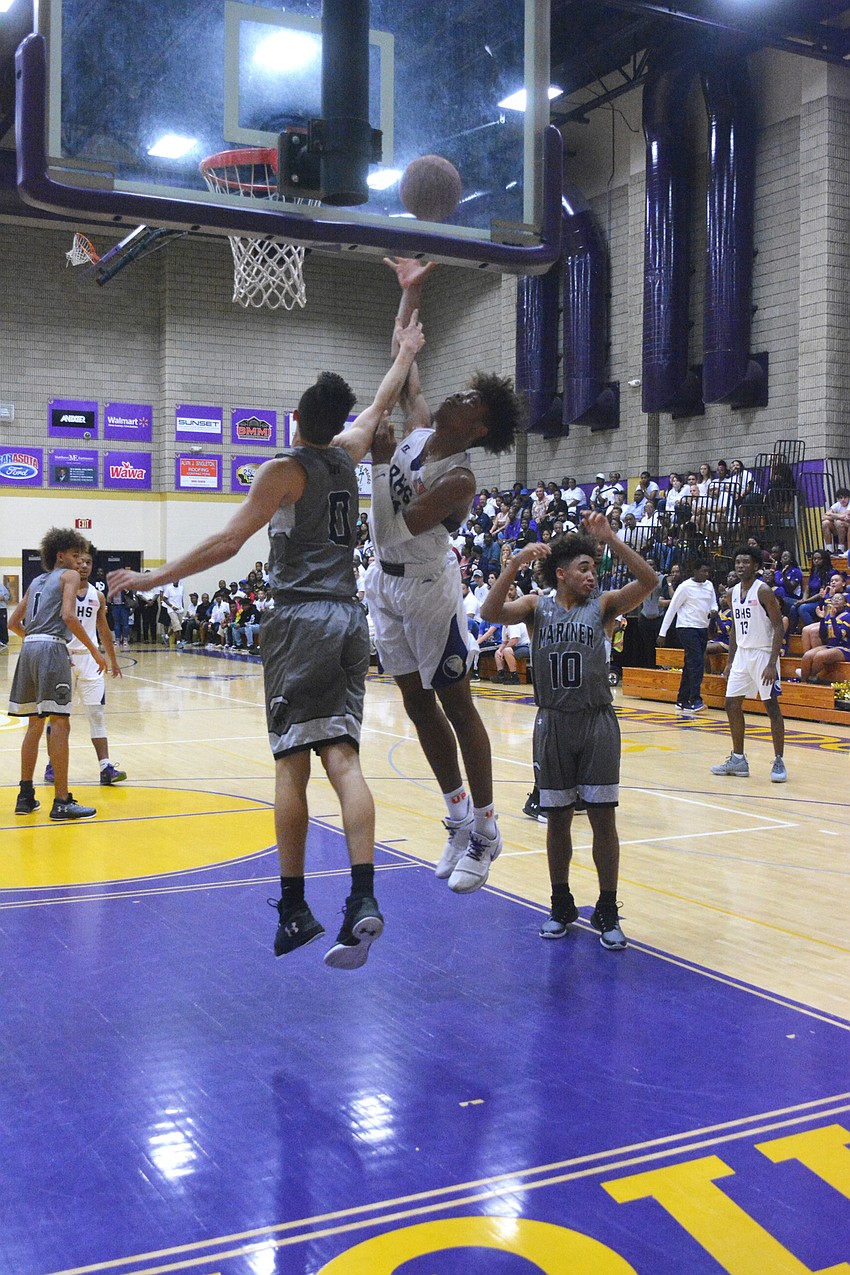 Johnnie Williams IV banks home a close shot over a Mariner defender in the second quarter.