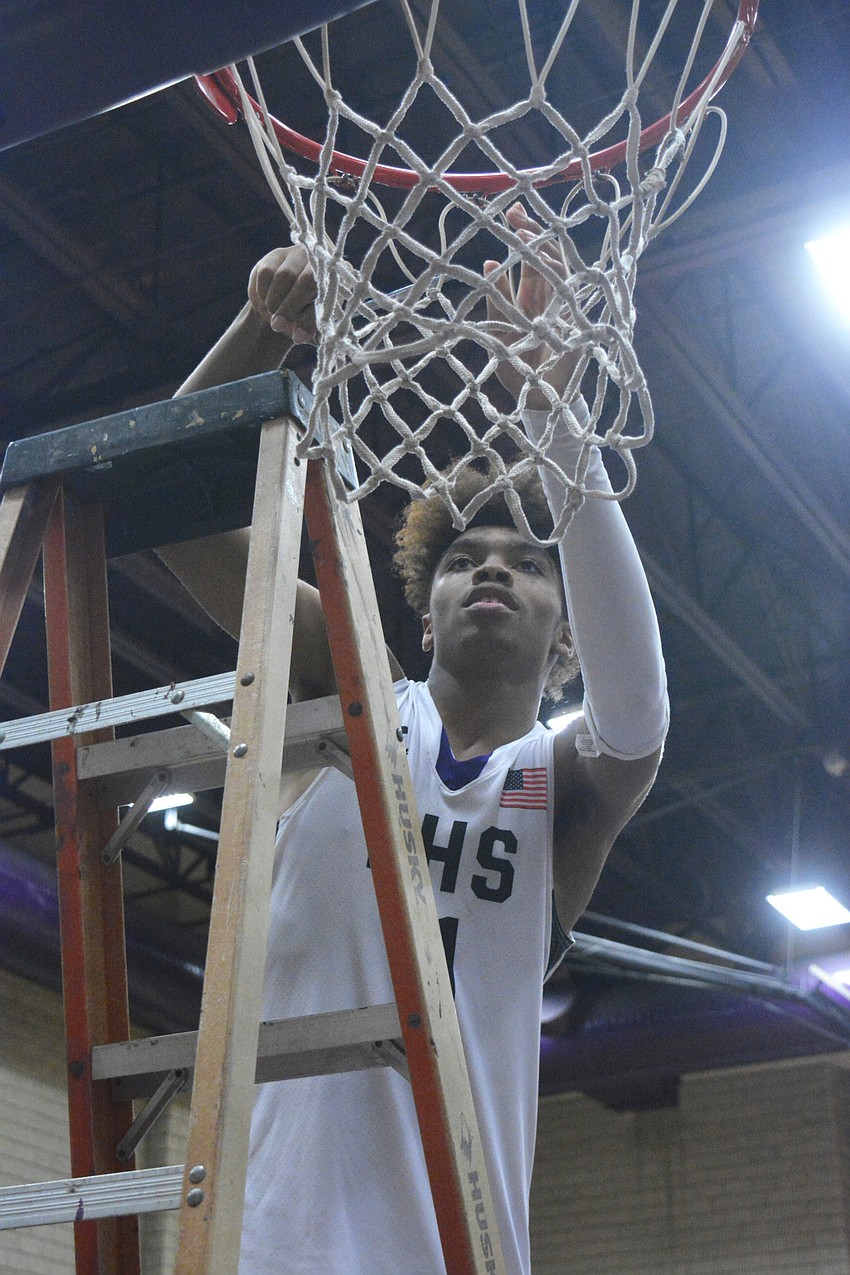Johnnie Williams IV was the first Tornadoes player to cut down the nets.