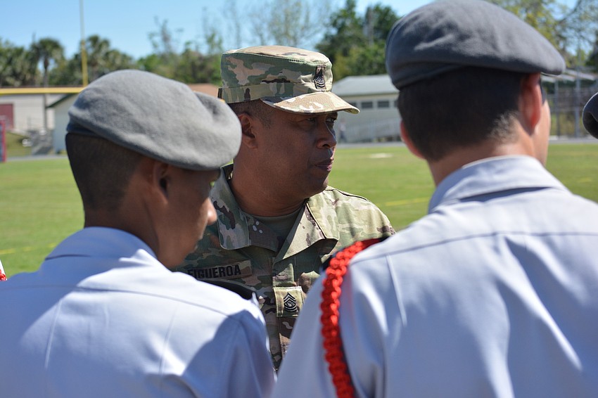 Command Sergeant Major Alexander Figueroa gives instructions to Jordan Feroze and Blake Smith before the Squad Exhibition drill.