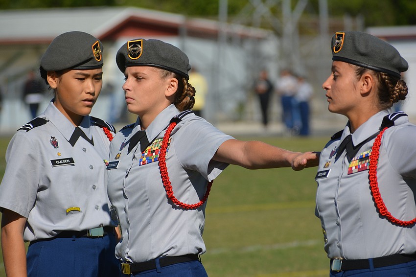 Ayaka Queson, the team commander of the Unarmed Squad, Sarah Dussault and Adi McCane prepare for a drill.