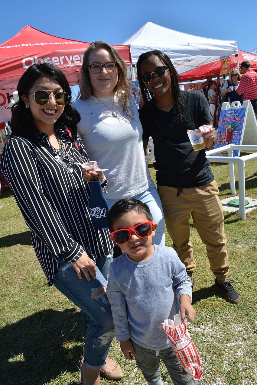 Mario Briones, 3, snacks on popcorn with his mom, Angela Navejar, and her friends Delaney Dunlop and Alex Anderson.