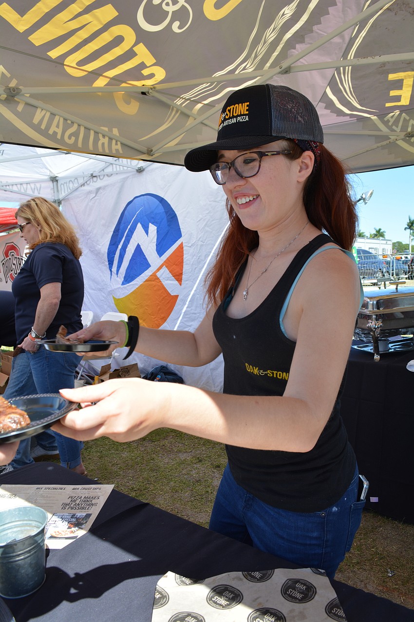 Oak and Stone employee Kellie de Treville serves up ribs to guests.