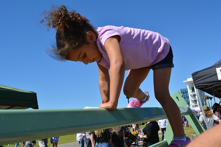 Three-year-old Asha Mayorga-Rao completes the Sarasota County Sheriff's Office SWAT team's obstacle course.