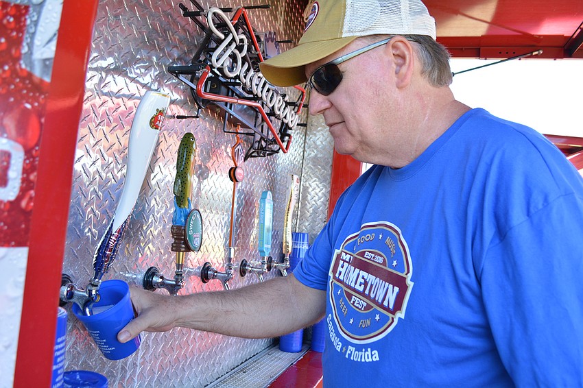 Sertoma Club member and volunteer Rod Underdahl  serves up a Stella Artois, among other beers available for purchase.