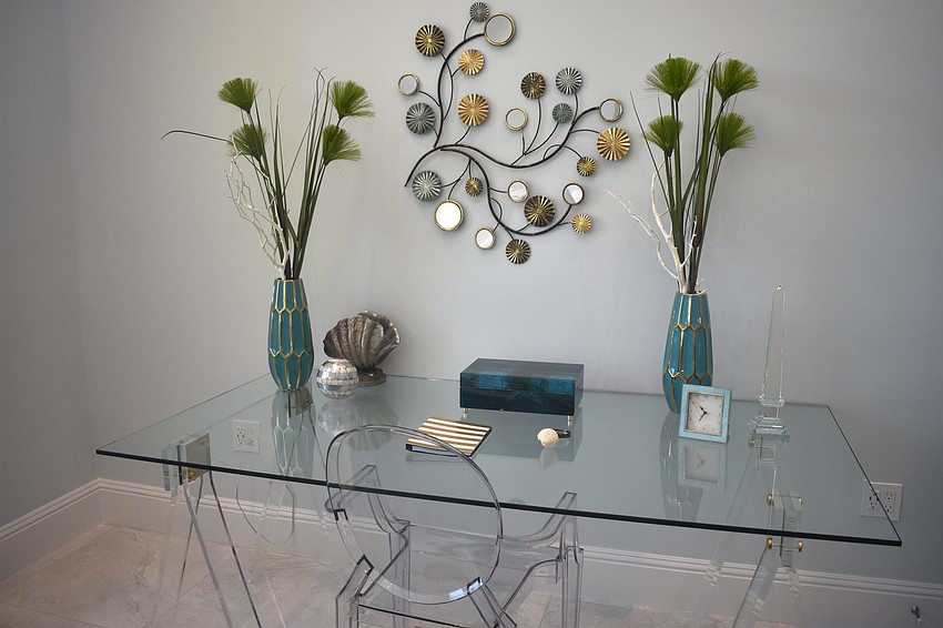 A clear desk with earthly-colored accents completes the master bedroom.