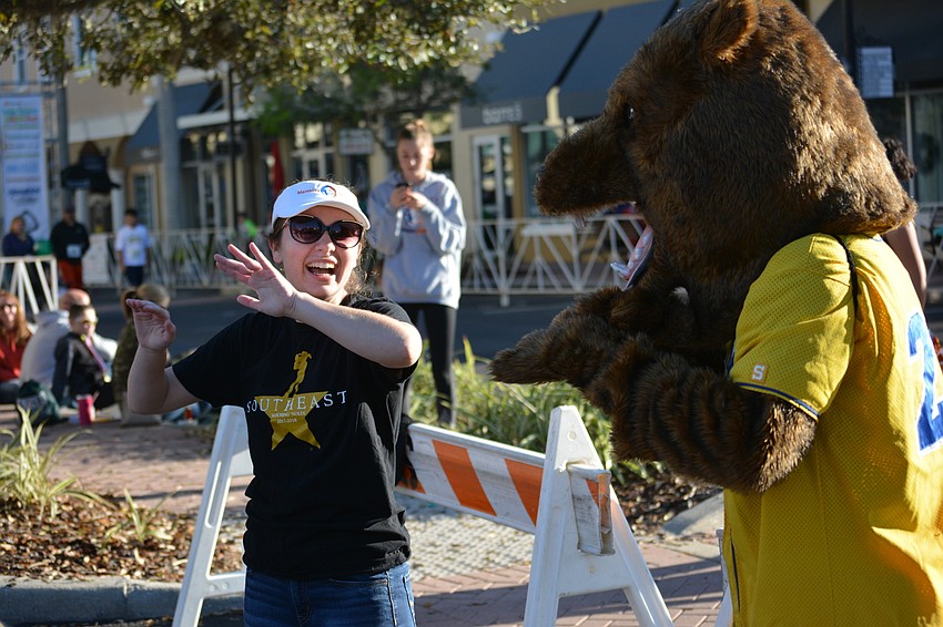 Maddie Whittemore, a Southeast High drum major, gets directing help from the Bayshore High Bruin (senior Theo Davis).