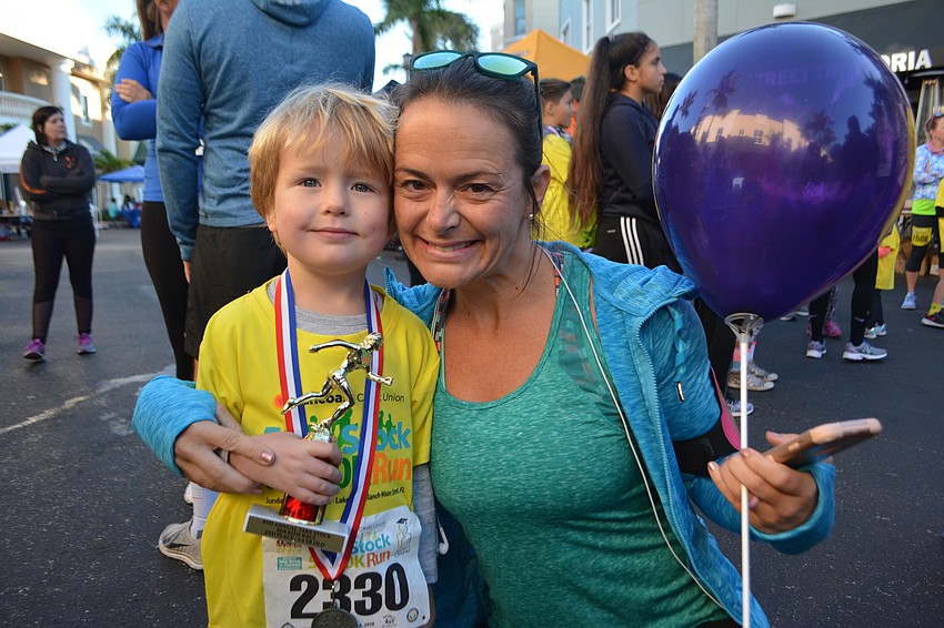 Heritage Harbour's Henry Kriby, 4, gives his mom, Jessica, a hug after earning a trophy.