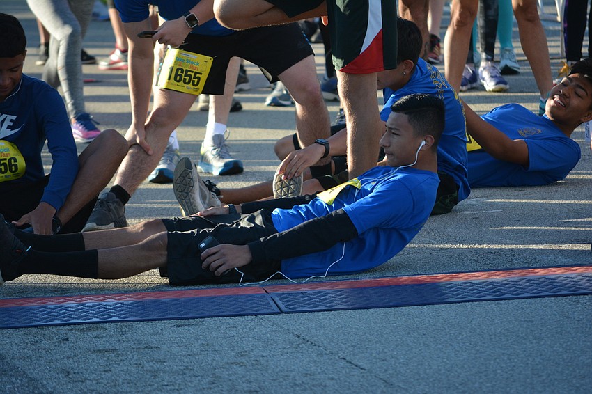 Eddie Palencia, 17, of Bayshore High warms up for the 10K race.