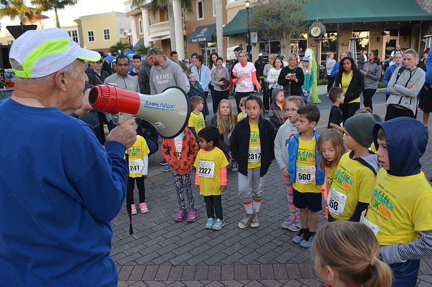 Race Director Doug Schiller gives instructions before the Fun Run.