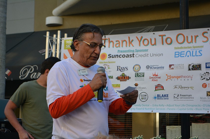 Take Stock Executive Director Jamie Serino hands out awards following the kids' races.