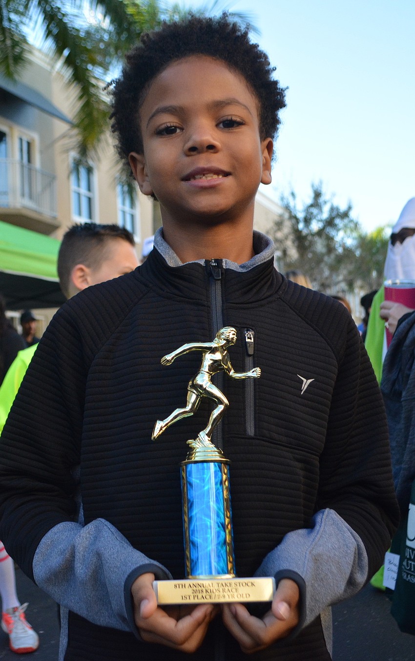 GreyHawk's Zachariah Kersey, 9, shows off his trophy for winning his age division.