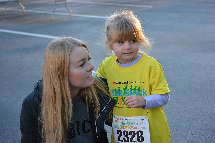 Lakewood Ranch's Tatum Gordon gives encouragement to her 4-year-old daughter, River, before the race. The Gordons were representing Clean Juice, a new business at the Mall at University Town Center.