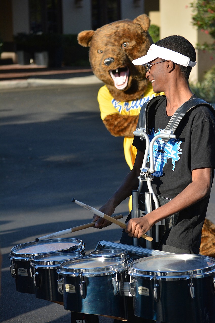 Southeast High drummer Kaleb Benony gets unexpected help from the Bayshore Bruin mascot, Theo Davis.