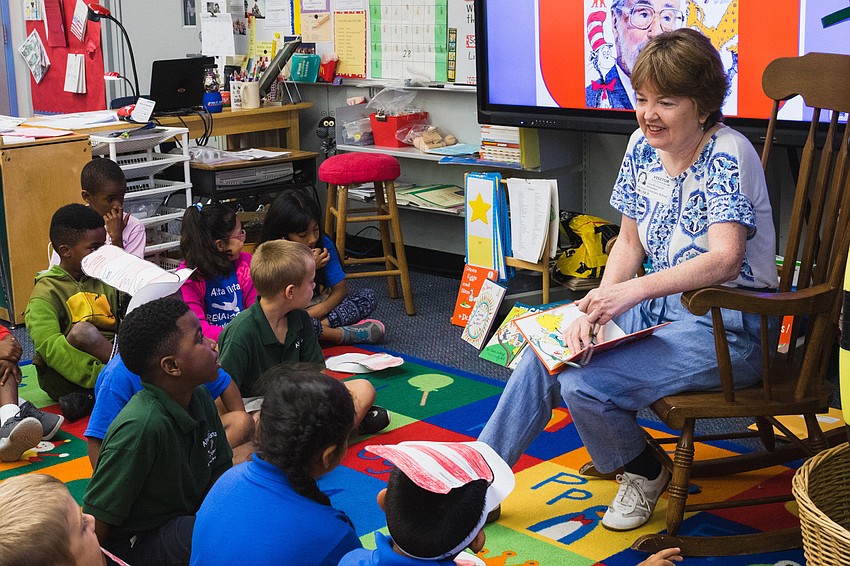 Volunteer Julia Blumquist reads to a first grade class at Alta Vista Elementary.