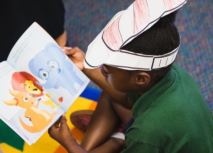 Na'Riyah Johnson reads her copy of 