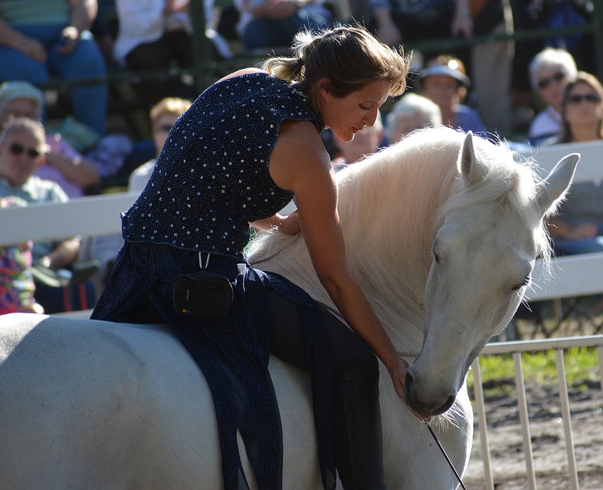 Rebecca McCullough, the daughter of farm owner Gabby Herrmann, offers a sugar treat for a job well done.